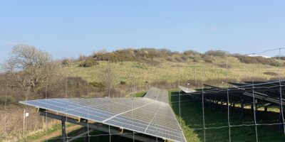 Ground-mounted solar panel array in an open field